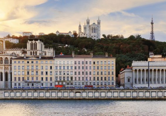 Colorful, cloudy sunset over Vieux Lyon and Fourviere Basilica seen from the riverbank of the Saone, Lyon.